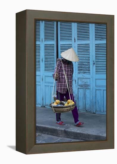 Vietnam. Street vendor with fruit and vegetable basket. Hoi Anh.-Tom Norring-Framed Premier Image Canvas