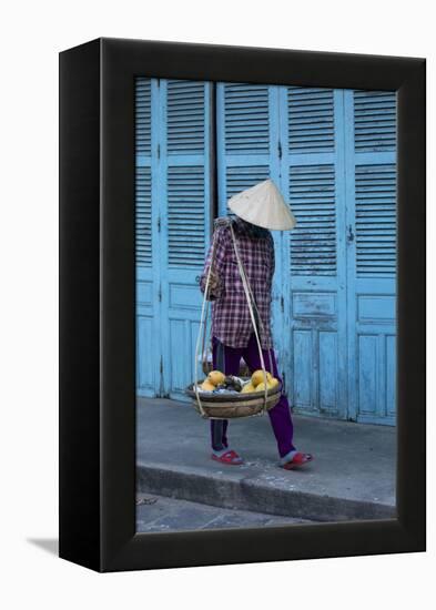 Vietnam. Street vendor with fruit and vegetable basket. Hoi Anh.-Tom Norring-Framed Premier Image Canvas