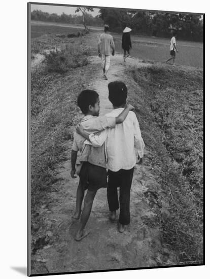 Vietnamese Farm People Walking on Raised Path Between Rice Paddies-John Dominis-Mounted Photographic Print