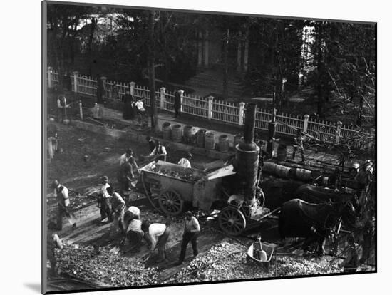 View from Above of Many Men Hard at Work Paving a Street-George B^ Brainerd-Mounted Photographic Print