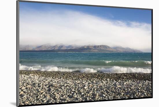 View from rocky shoreline across the stormy waters of Lake Pukaki, near Twizel, Mackenzie district,-Ruth Tomlinson-Mounted Photographic Print