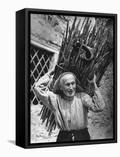 View of a Man Carrying a Big Bundle of Sticks from a Story Concerning Italy-Thomas D^ Mcavoy-Framed Premier Image Canvas