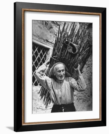 View of a Man Carrying a Big Bundle of Sticks from a Story Concerning Italy-Thomas D^ Mcavoy-Framed Photographic Print