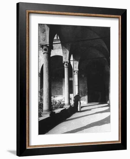 View of a Monk Walking the Grounds of a Church in Milan-Carl Mydans-Framed Photographic Print