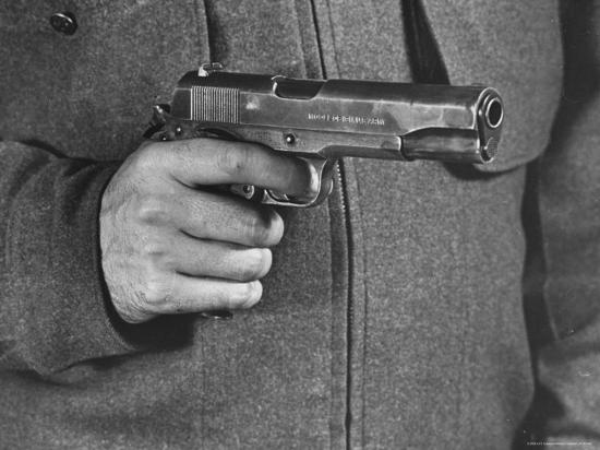 'View of a Soldier Holding a US Army Colt Automatic .45 Caliber Pistol ...
