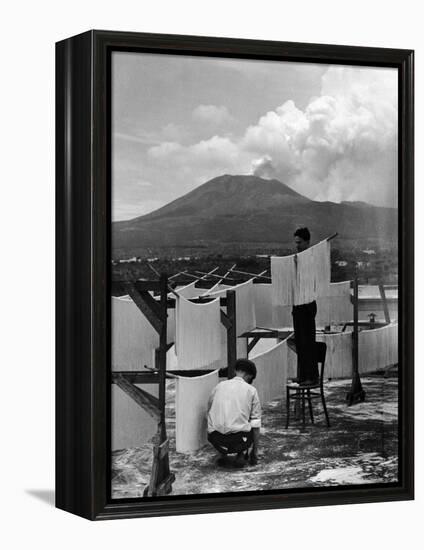 View of Mount Vesuvius from the Town of Torre Annunciata with Men Tending to Drying Pasta-Alfred Eisenstaedt-Framed Premier Image Canvas