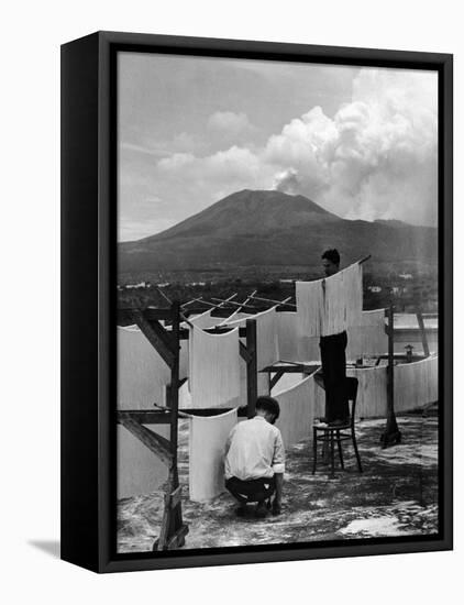 View of Mount Vesuvius from the Town of Torre Annunciata with Men Tending to Drying Pasta-Alfred Eisenstaedt-Framed Premier Image Canvas