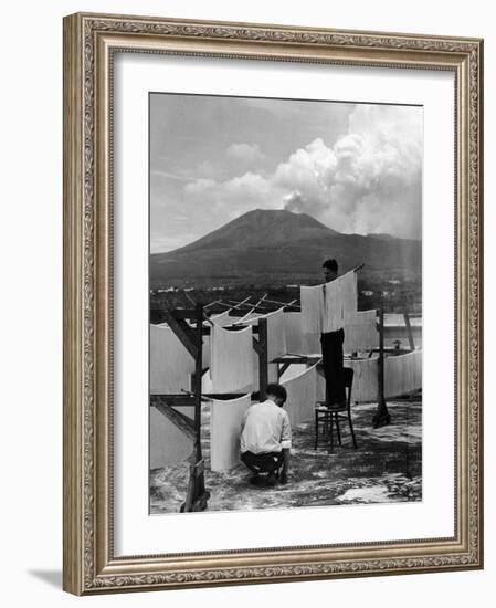 View of Mount Vesuvius from the Town of Torre Annunciata with Men Tending to Drying Pasta-Alfred Eisenstaedt-Framed Photographic Print