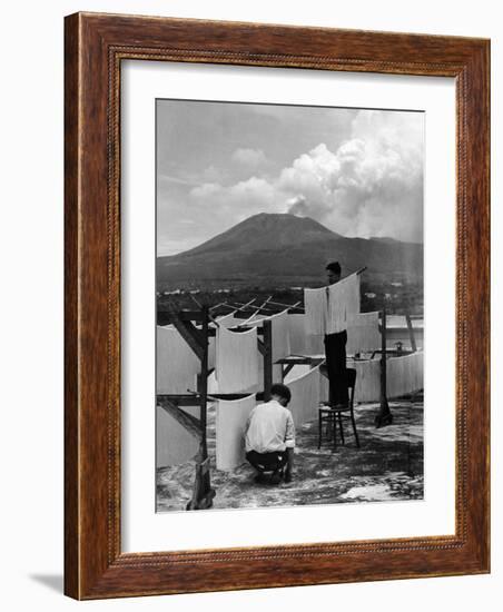 View of Mount Vesuvius from the Town of Torre Annunciata with Men Tending to Drying Pasta-Alfred Eisenstaedt-Framed Photographic Print