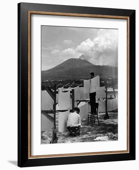 View of Mount Vesuvius from the Town of Torre Annunciata with Men Tending to Drying Pasta-Alfred Eisenstaedt-Framed Photographic Print