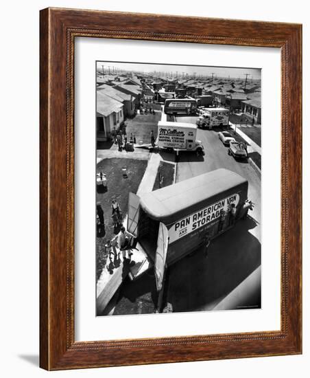 View of Newly Built Houses Jammed Side by Side, Divided by a Street Clogged with Moving Vans-J^ R^ Eyerman-Framed Photographic Print