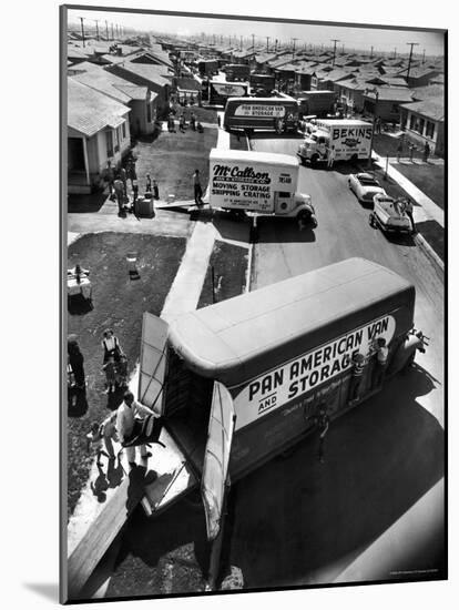 View of Newly Built Houses Jammed Side by Side, Divided by a Street Clogged with Moving Vans-J^ R^ Eyerman-Mounted Photographic Print