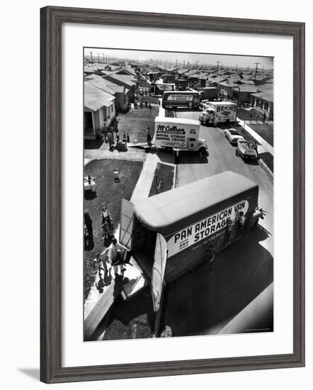 View of Newly Built Houses Jammed Side by Side, Divided by a Street Clogged with Moving Vans-J^ R^ Eyerman-Framed Photographic Print