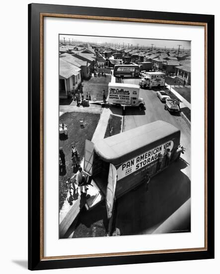 View of Newly Built Houses Jammed Side by Side, Divided by a Street Clogged with Moving Vans-J^ R^ Eyerman-Framed Photographic Print