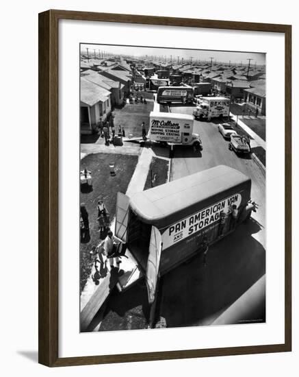 View of Newly Built Houses Jammed Side by Side, Divided by a Street Clogged with Moving Vans-J^ R^ Eyerman-Framed Photographic Print