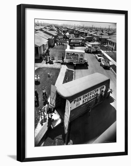 View of Newly Built Houses Jammed Side by Side, Divided by a Street Clogged with Moving Vans-J^ R^ Eyerman-Framed Photographic Print