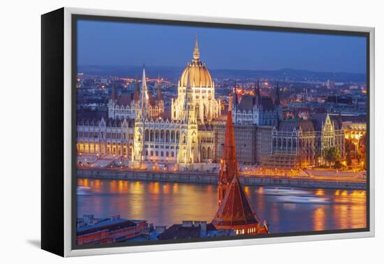 View of Parliament Buildings along Danube River at dusk, Budapest, Capital of Hungary-Tom Haseltine-Framed Premier Image Canvas
