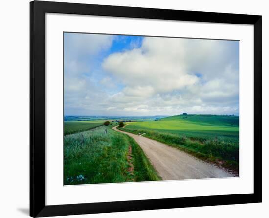 View of road passing through a field, United Kingdom-null-Framed Photographic Print