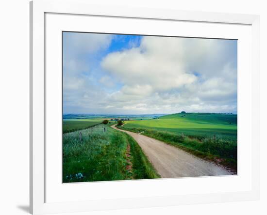 View of road passing through a field, United Kingdom-null-Framed Photographic Print