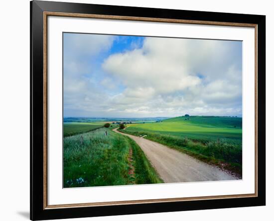 View of road passing through a field, United Kingdom-null-Framed Photographic Print