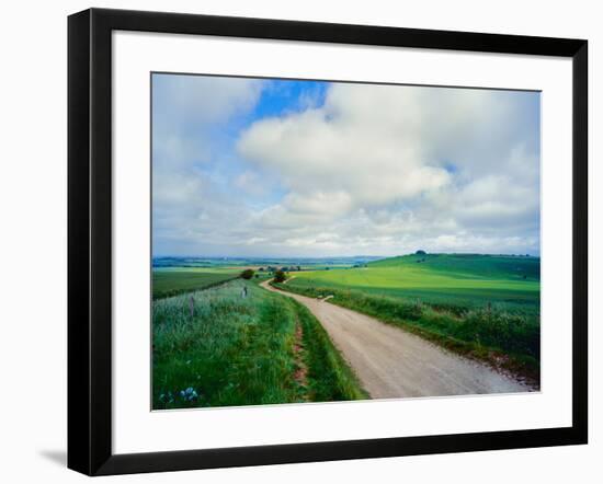 View of road passing through a field, United Kingdom-null-Framed Photographic Print