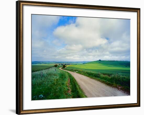 View of road passing through a field, United Kingdom-null-Framed Photographic Print