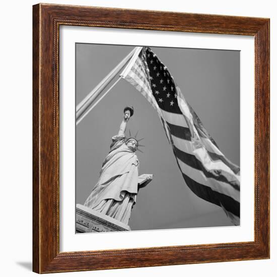 View of Statue of Liberty and American Flag-Bettmann-Framed Photographic Print