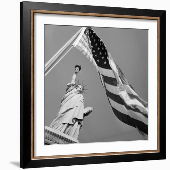 View of Statue of Liberty and American Flag-Bettmann-Framed Photographic Print