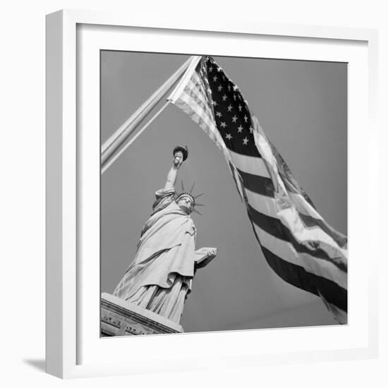 View of Statue of Liberty and American Flag-Bettmann-Framed Photographic Print