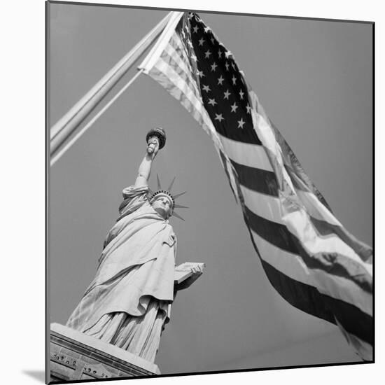 View of Statue of Liberty and American Flag-Bettmann-Mounted Photographic Print