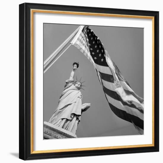 View of Statue of Liberty and American Flag-Bettmann-Framed Photographic Print