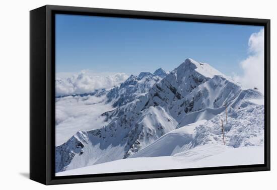 View on Winter Snowy Mountains and Blue Sky above Clouds, Krasnaya Polyana, Sochi, Russia-wasja-Framed Premier Image Canvas