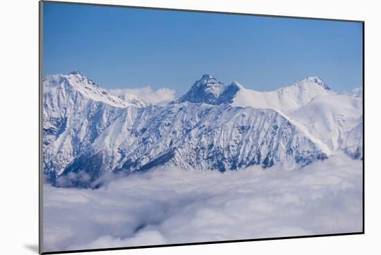 View on Winter Snowy Mountains and Blue Sky above Clouds, Krasnaya Polyana, Sochi, Russia-wasja-Mounted Photographic Print