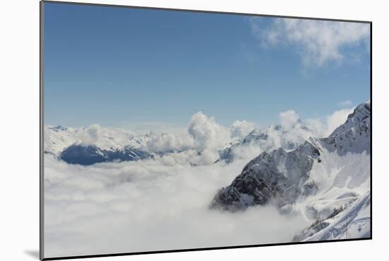 View on Winter Snowy Mountains and Blue Sky above Clouds, Krasnaya Polyana, Sochi, Russia-wasja-Mounted Photographic Print