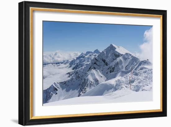 View on Winter Snowy Mountains and Blue Sky above Clouds, Krasnaya Polyana, Sochi, Russia-wasja-Framed Photographic Print