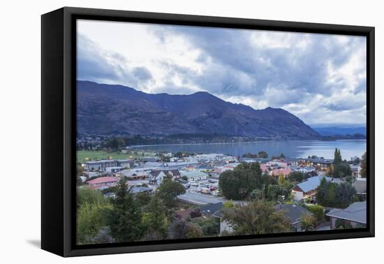 View over rooftops to Lake Wanaka at dusk, Wanaka, Queenstown-Lakes district, Otago, South Island, -Ruth Tomlinson-Framed Premier Image Canvas