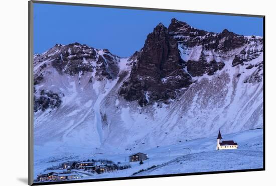 Vik i Myrdal Church, floodlit at twilight after snowfall, Vik, Iceland. December 2017.-Ross Hoddinott-Mounted Photographic Print