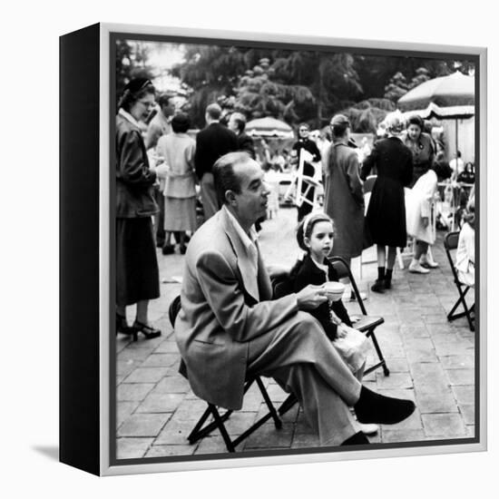 Vincente Minnelli with coffee sitting in chair with Daughter Liza at Outdoor Children's Party Being-J^ R^ Eyerman-Framed Premier Image Canvas