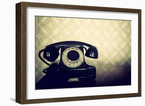 Vintage Old Telephone, Black Retro Phone Is On Wooden Table Over Green Old-Fashioned Wallpaper-khorzhevska-Framed Art Print