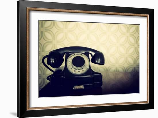 Vintage Old Telephone, Black Retro Phone Is On Wooden Table Over Green Old-Fashioned Wallpaper-khorzhevska-Framed Art Print