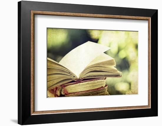 Vintage Photo of Old Books on Colorful Bokeh Background-melis-Framed Photographic Print