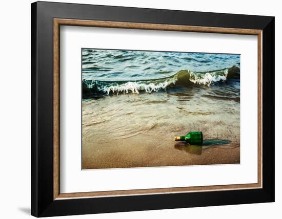 Vintage Retro Hipster Style Travel Image of Message Bottle on Beach Sand in Waves-f9photos-Framed Photographic Print