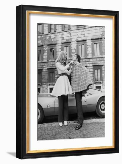 Vogue - April 1969 - Veruschka Adjusts Tomas Milian's Cape-Franco Rubartelli-Framed Premium Photographic Print