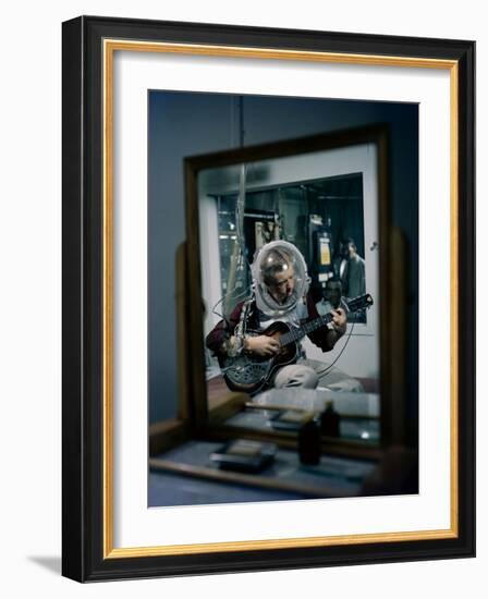 Volunteer Wearing Plastic Helmet Plays a Steel Guitar for Nih Expericment, Bethesda, Maryland, 1958-Yale Joel-Framed Photographic Print