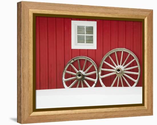 Wagon Wheels on Snow Against Stable-Stuart Westmorland-Framed Premier Image Canvas