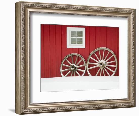 Wagon Wheels on Snow Against Stable-Stuart Westmorland-Framed Photographic Print