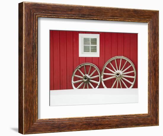 Wagon Wheels on Snow Against Stable-Stuart Westmorland-Framed Photographic Print