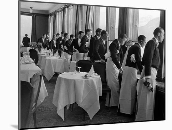 Waiters at the Grand Hotel Line Up at the Windows to Watch Sonja Henie Ice Skate Outside-Alfred Eisenstaedt-Mounted Photographic Print