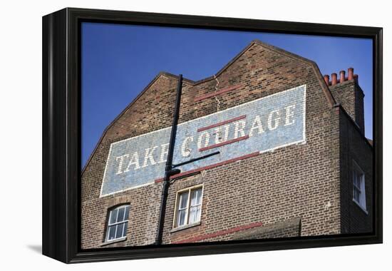 Wall Mural Inscribed with 'Take Courage' Slogan on an End of Terrace Brick House Built around 1807-Julian Castle-Framed Stretched Canvas