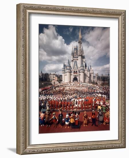 Walt Disney Characters and Park Staff Posing En Masse in Front of Cinderella's Castle-Yale Joel-Framed Photographic Print